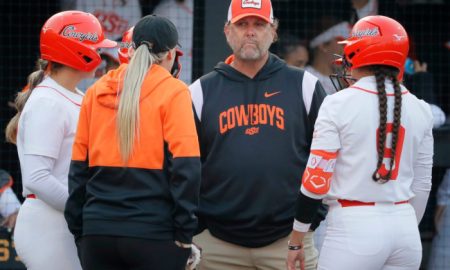 Oklahoma State coach Kenny Gajewski talks with players during a game between the Oklahoma State Cowgirls (OSU) and the UMBC Retrievers in the Stillwater Regional of the NCAA softball tournament in Stillwater, Okla., Friday, May 19, 2023. Oklahoma State won 9-0.