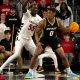 Bryant Bulldogs guard Earl Timberlake (0) handles the ball as Cincinnati Bearcats forward Aziz Bandaogo (55) guards him in the first half of the NCAA Basketball game between the Bryant Bulldogs and Cincinnati Bearcats at Fifth Third Arena in Cincinnati on Tuesday, Dec. 12, 2023.