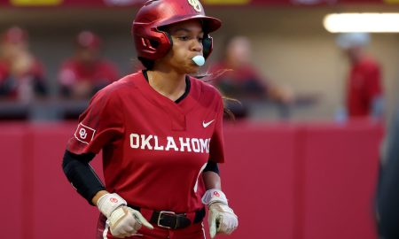Oklahoma's Rylie Boone (0) runs to first base after a walk during the college softball game between the University of Oklahoma Sooners and Texas A&M Commerce at Love's Field in Norman, Okla., Wednesday, March 6, 2024.